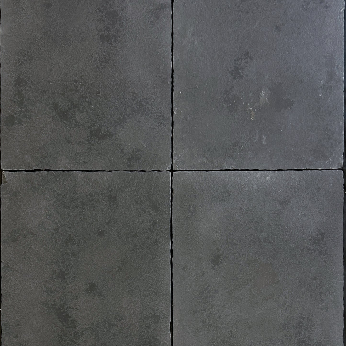 4 pieces of black velvet antiqued natural limestone, showing the natural color variation.