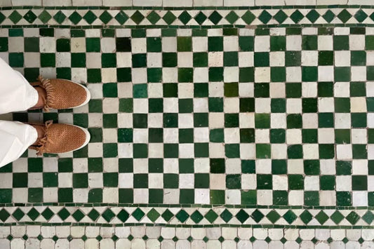 Person standing on a green and white checkered Zellige floor in Morocco.