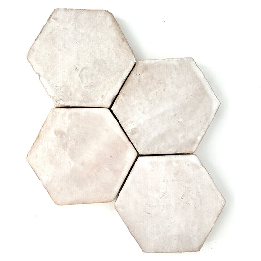 Hexagon Zellige tile in a varigated cream and white glaze.