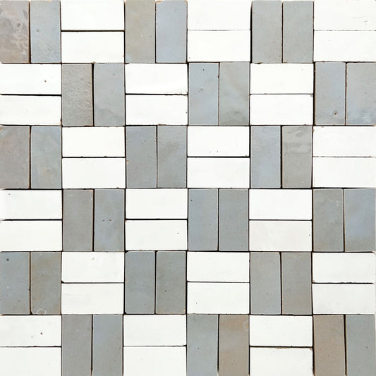 Zellige mosaic tile pattern that is made up of 1x2" pieces, and arranged to give a woven checkerboard feel. The tile colors are a varigated sky blue with hits of green and the natural terracotta color peeking through and white.