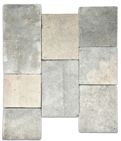 Eight limestone tiles in various shades of gray and beige on a white background.