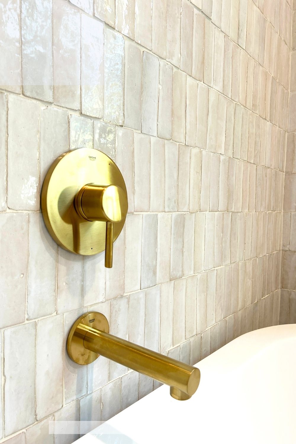 Gold bathroom fixtures on a Casablanca Tusk Zellige tiled wall